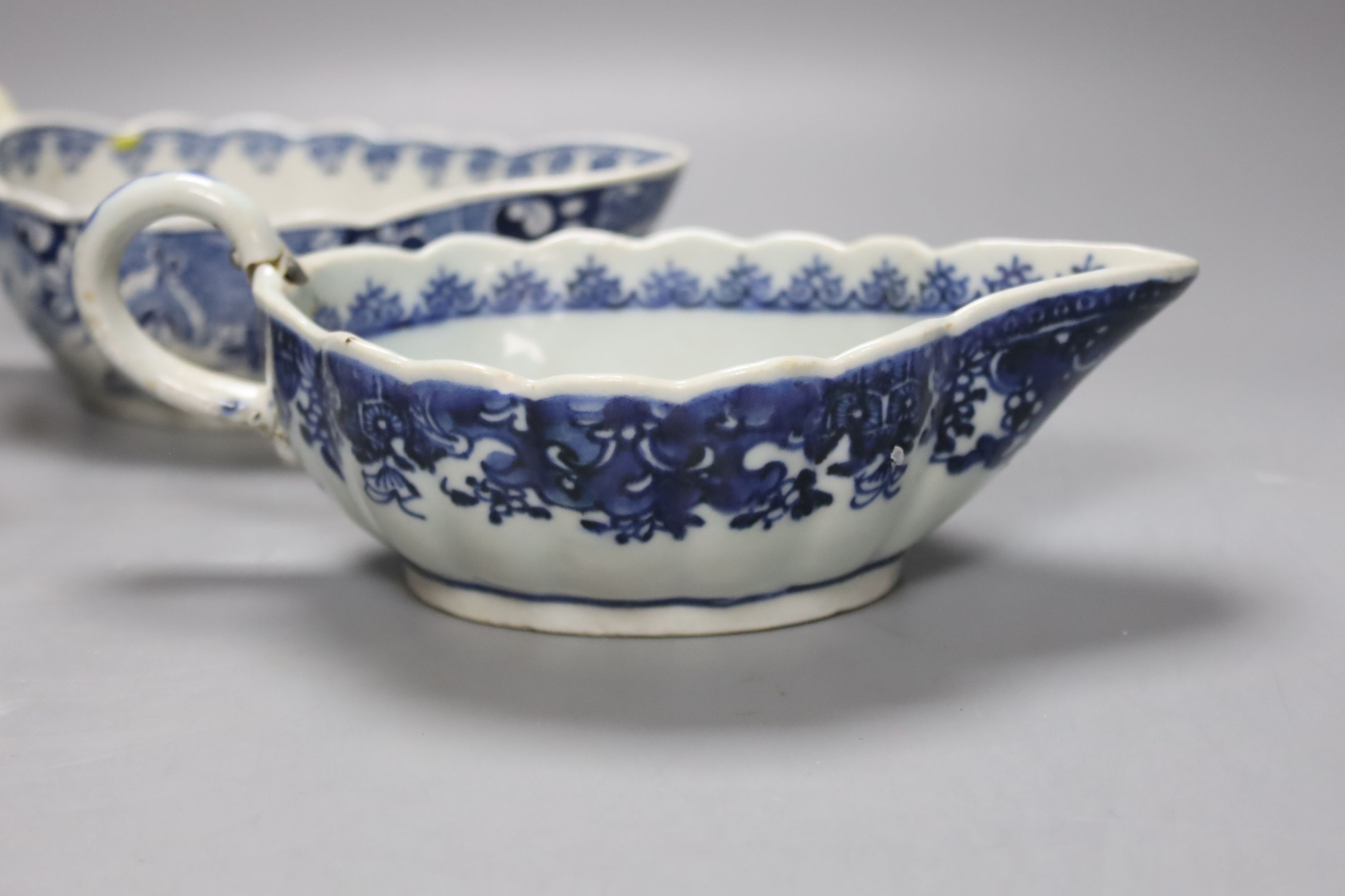 A Worcester Doughnut pattern blue and white sauceboat circa 1775 and two Chinese blue and white sauceboats, Qianlong period, longest 21cm